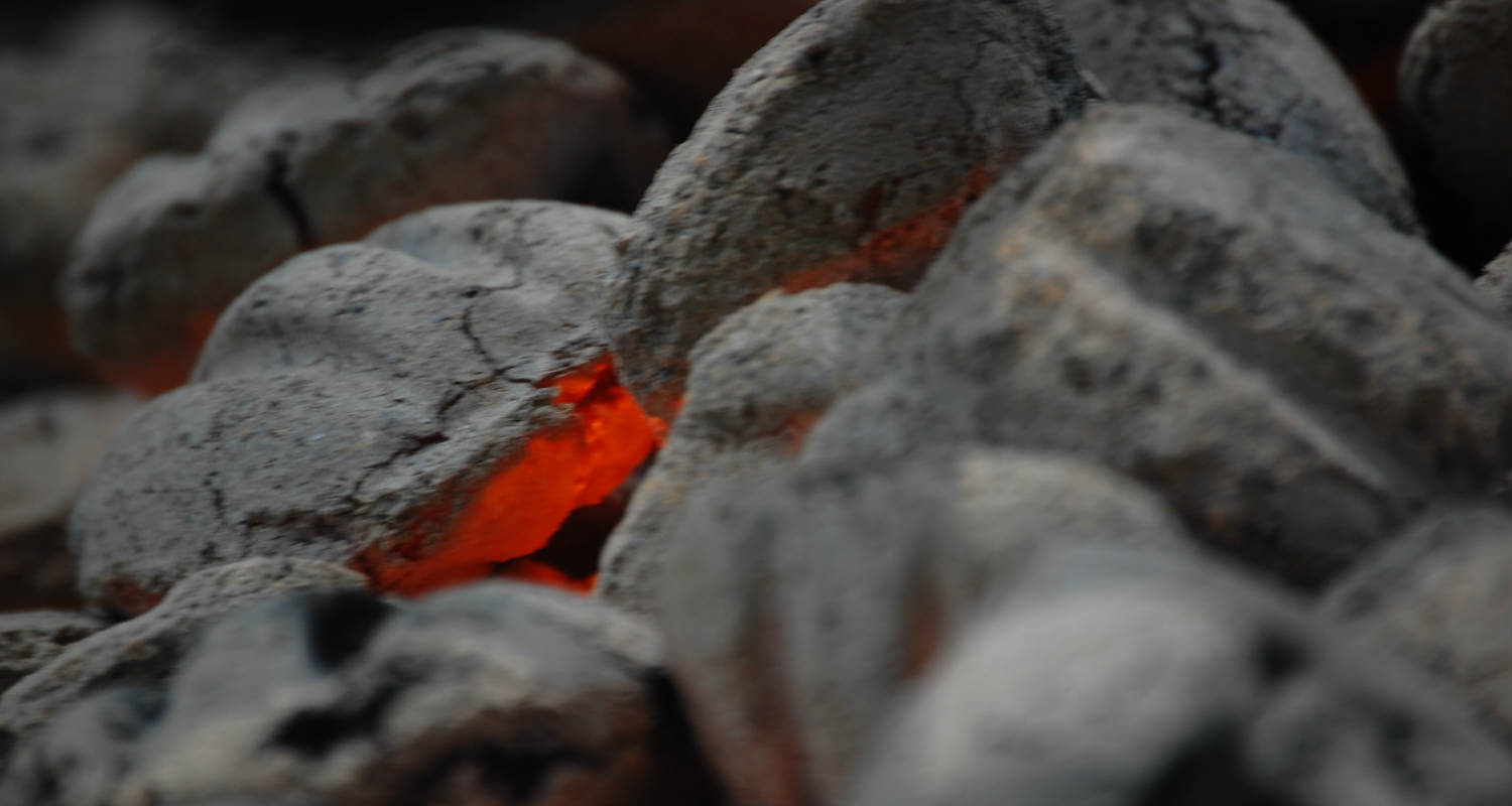 fire smoldering under hot coals