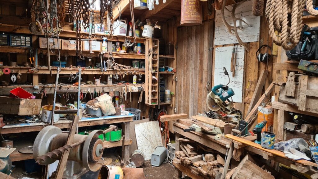 The interior of a cluttered, old woodworking workshop