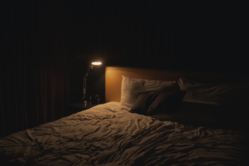 empty bed at night with light on (sleepwalking)