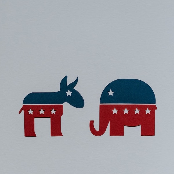 Symbols of Democrat and Republican parties cut out of paper